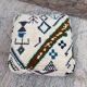 Berber floor pouf: Handwoven Moroccan wool cushion.