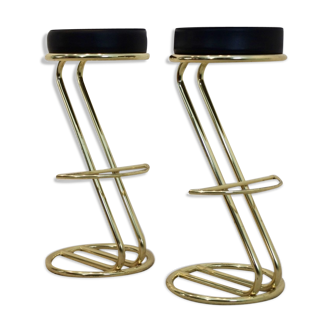Pair of brass bar stools with black leather seat, ‘80s