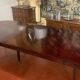 Directoire period extendable dining table in mahogany with a band.