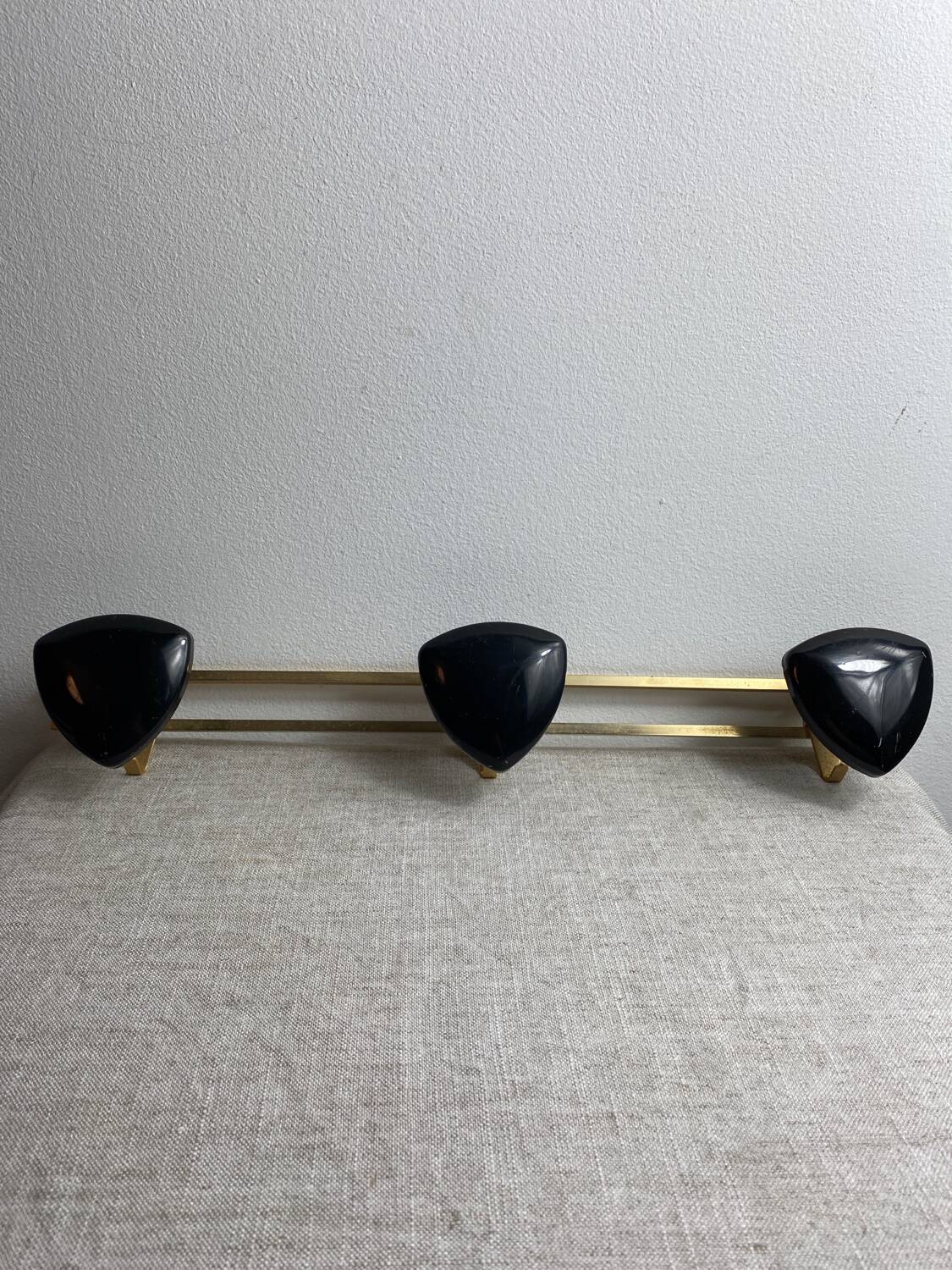 Wall-mounted coat rack with 3 hooks from the 1960s.
