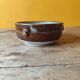 Old small glazed ceramic dish with lion head decoration - brown enamel kitchen bowl