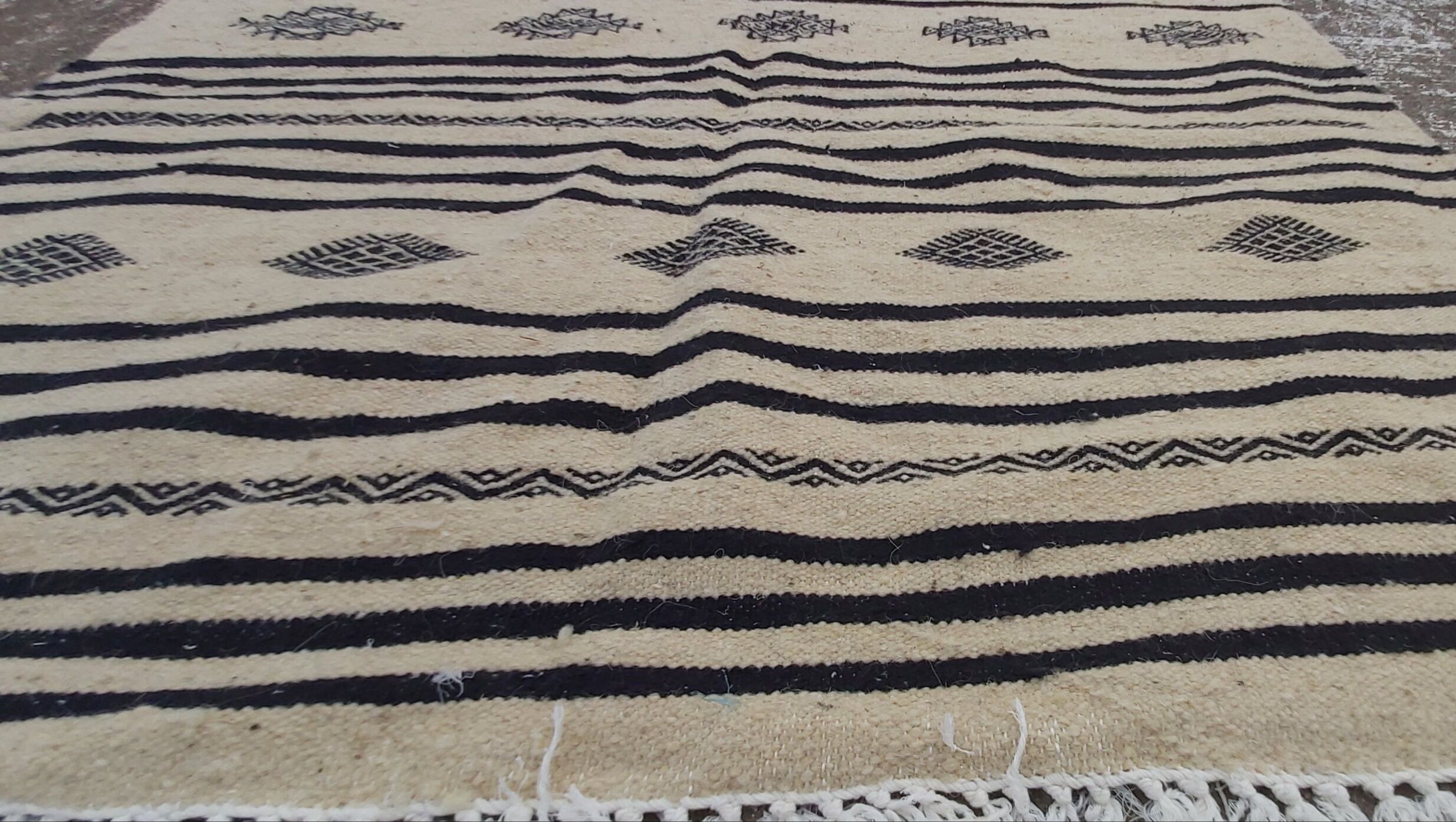 Traditional hand-woven beige and black carpet