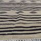 Traditional hand-woven beige and black carpet