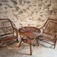 Vintage rattan lounge set, French wicker armchairs and round table, circa 1930–1950.