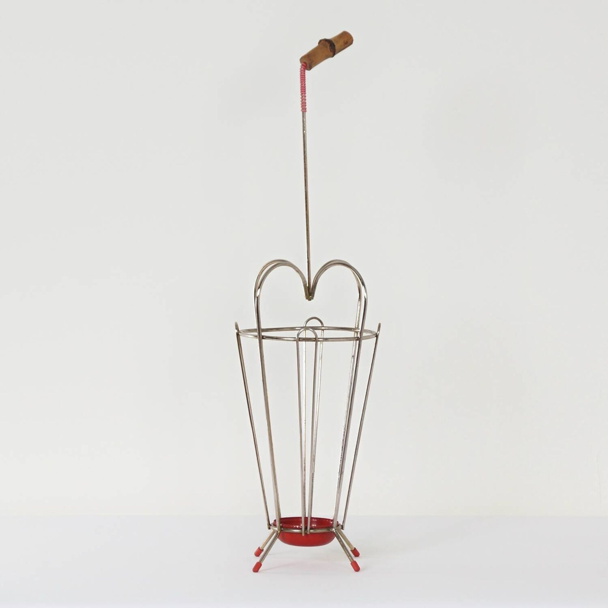 VINTAGE UMBRELLA STAND OF CURVED METAL, RED DETAILS AND A BAMBOO HANDLE, 1950S