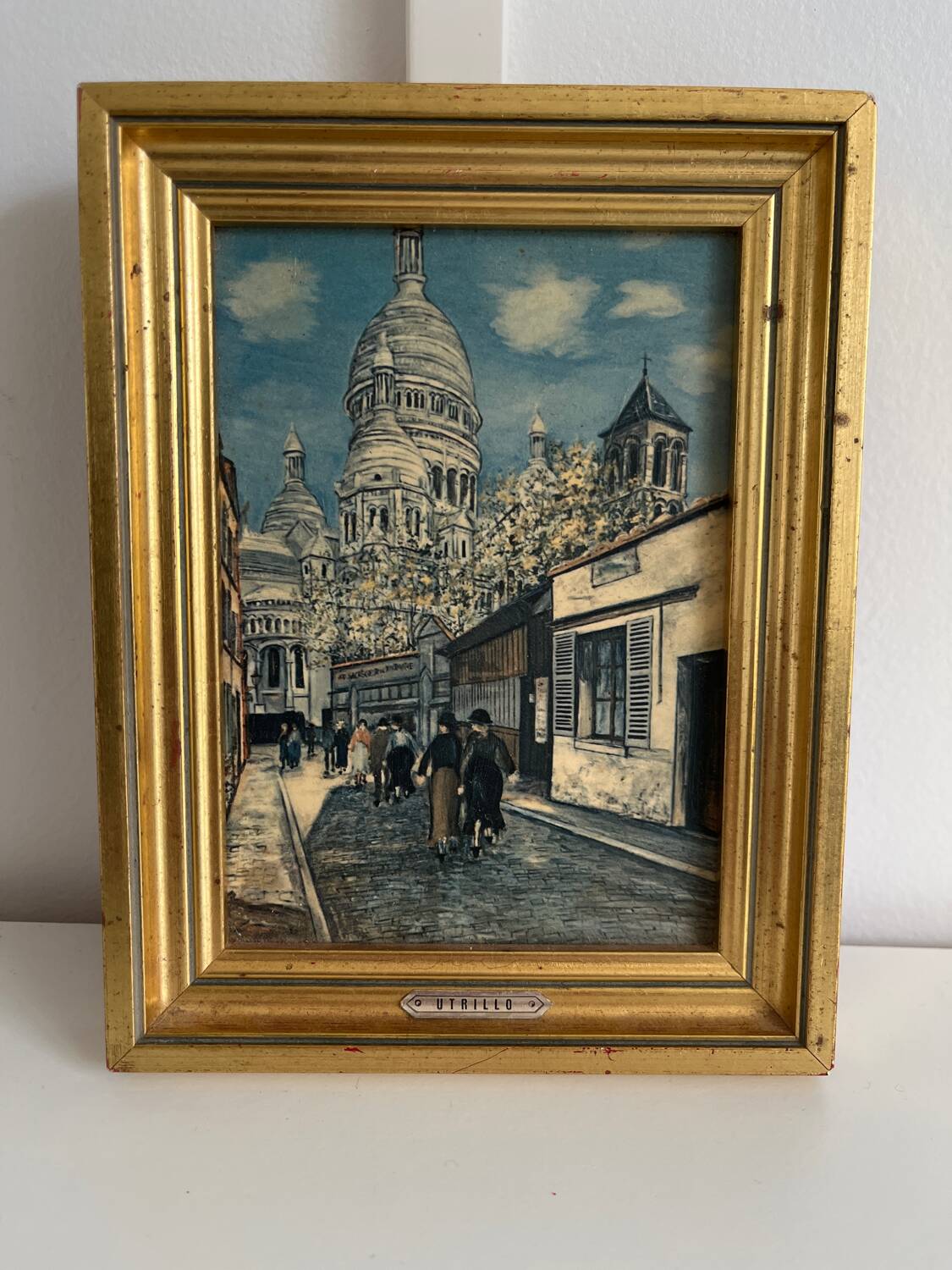 Reproduction of a painting of a walk in the city center by Maurice Trillon