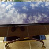 Chic serving table on wheels from the 60s with brass decorations and two shelves.