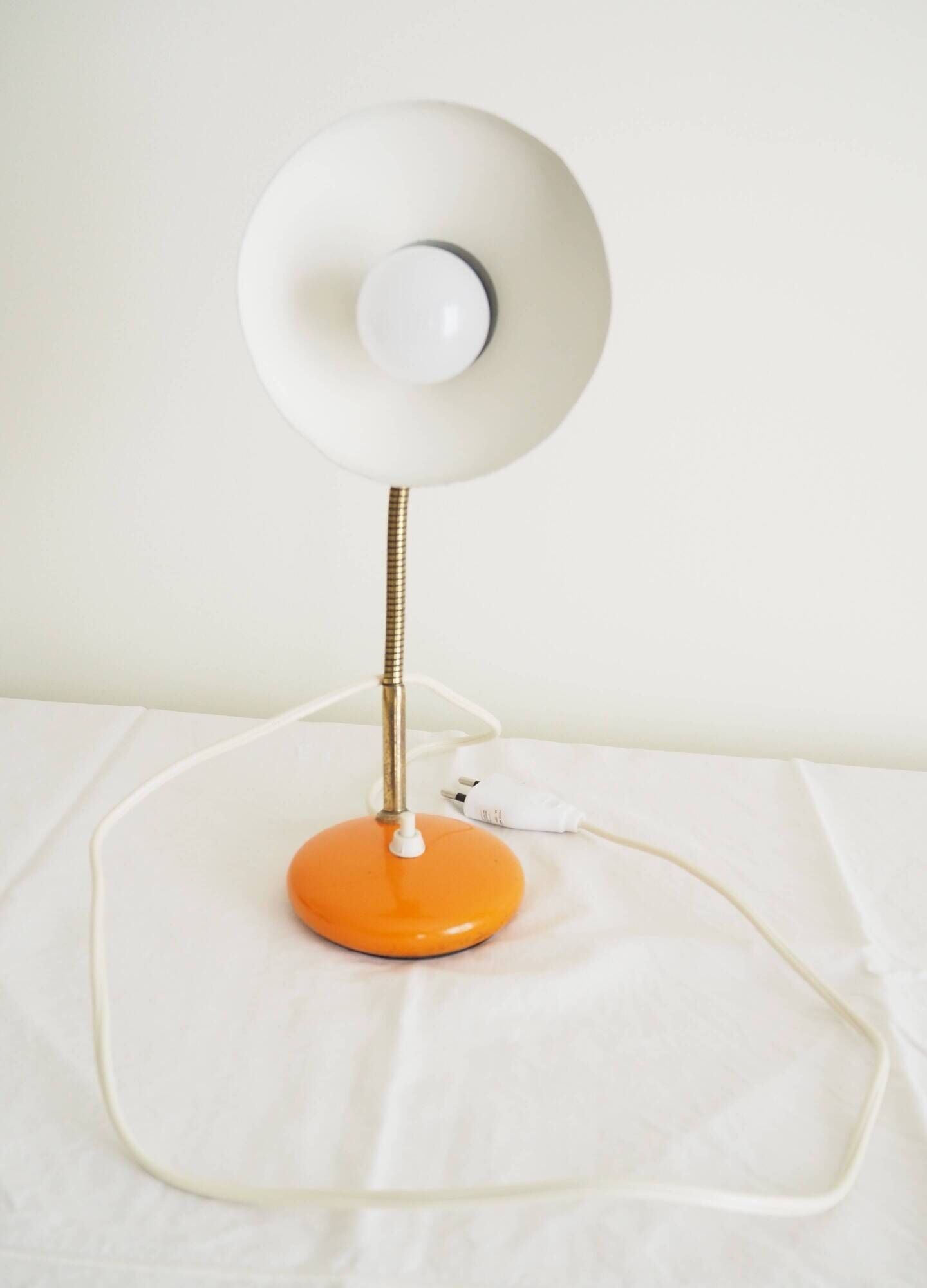 Orange colored metal desk lamp from the 1960s-1970s
