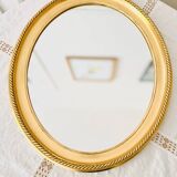Oval wall mirror in gilded wood