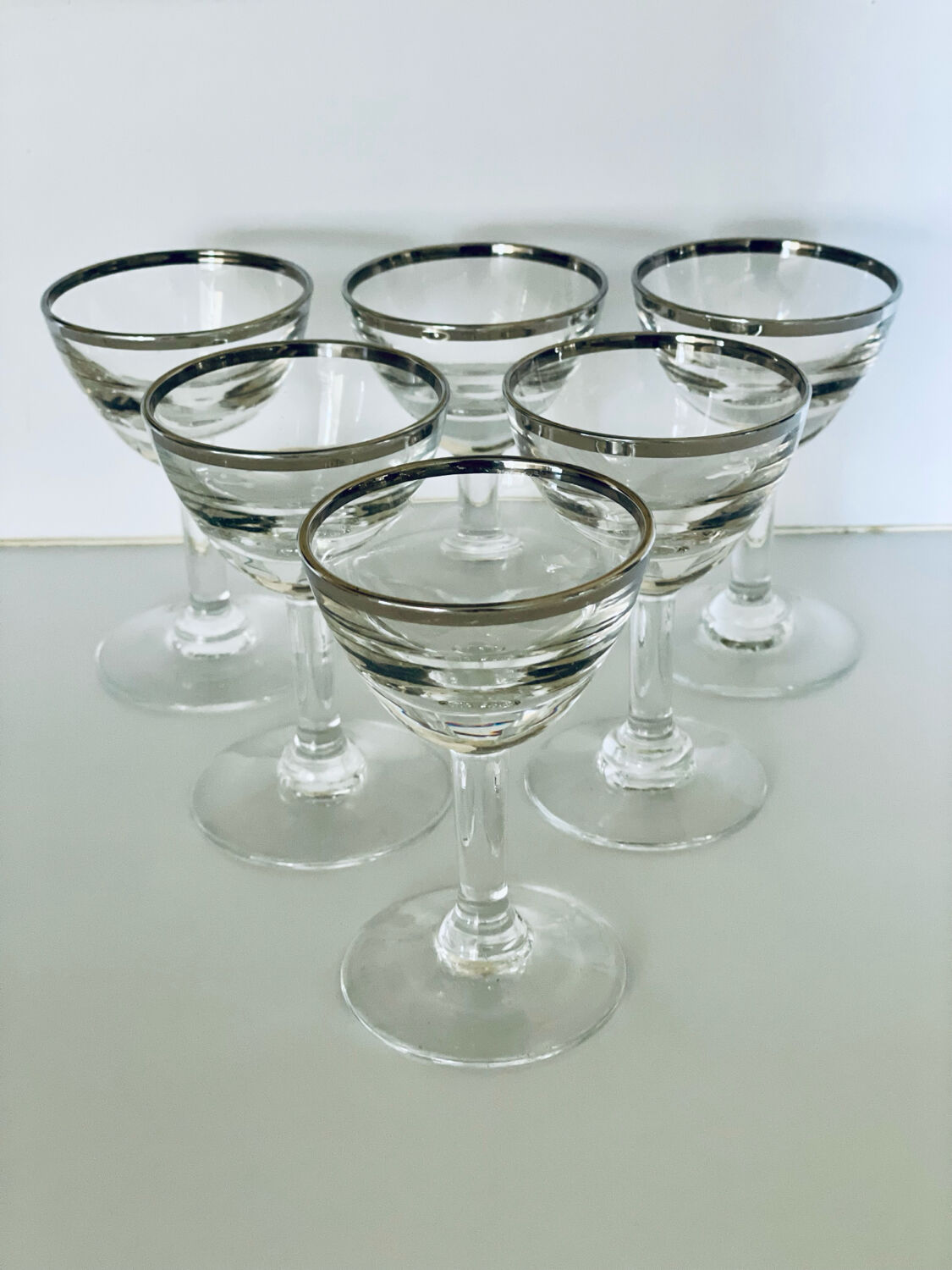 Set of 8 stemmed port glasses with silver trim.