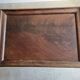 Antique wooden sewing cabinet with mirror and storage.