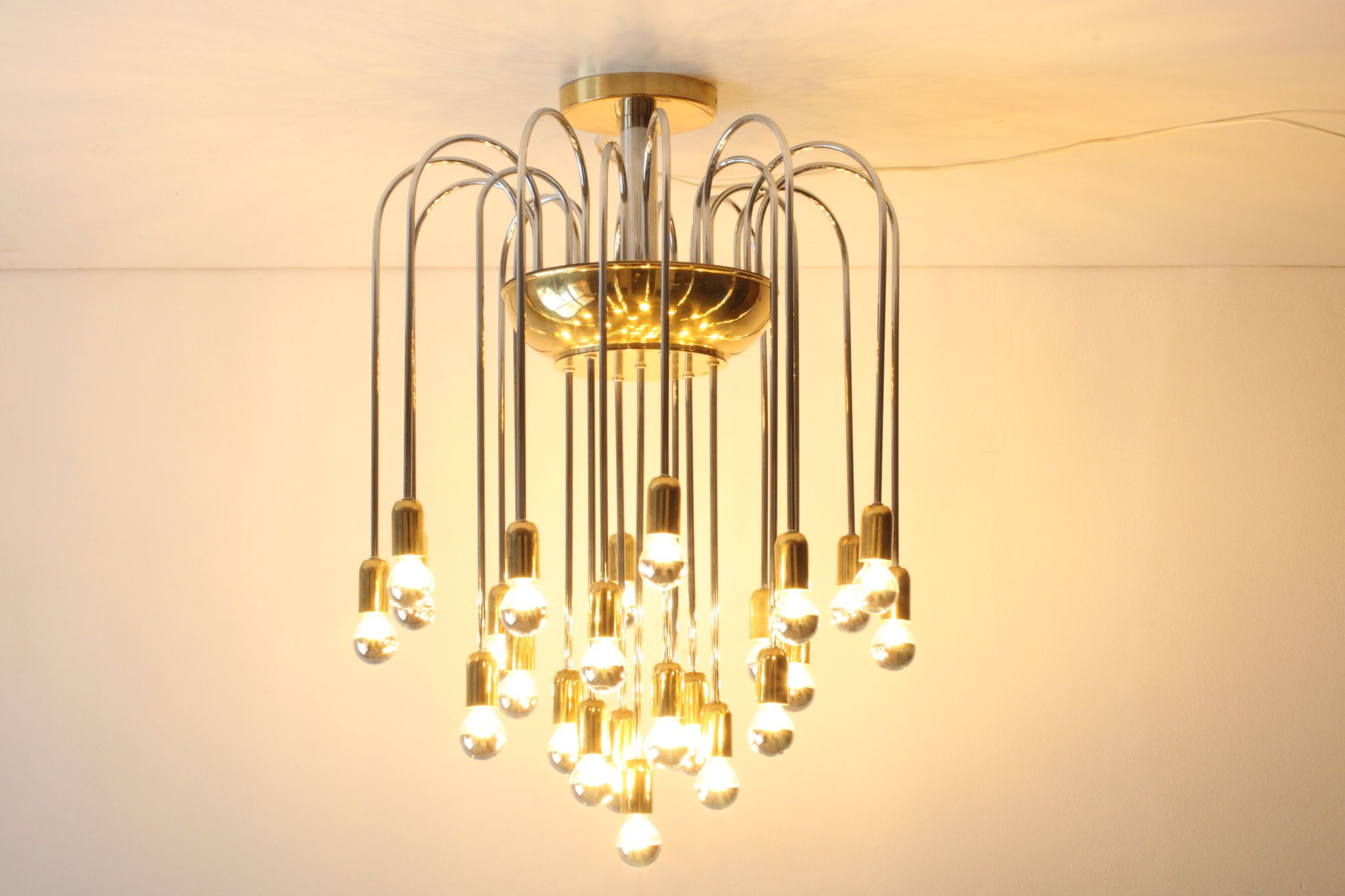 Tubular chrome and brass waterfall chandelier, Italy 1970s.