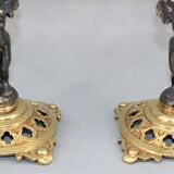 Pair of candle holders in gilded bronze and patinated with a candle
