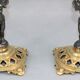 Pair of candle holders in gilded bronze and patinated with a candle