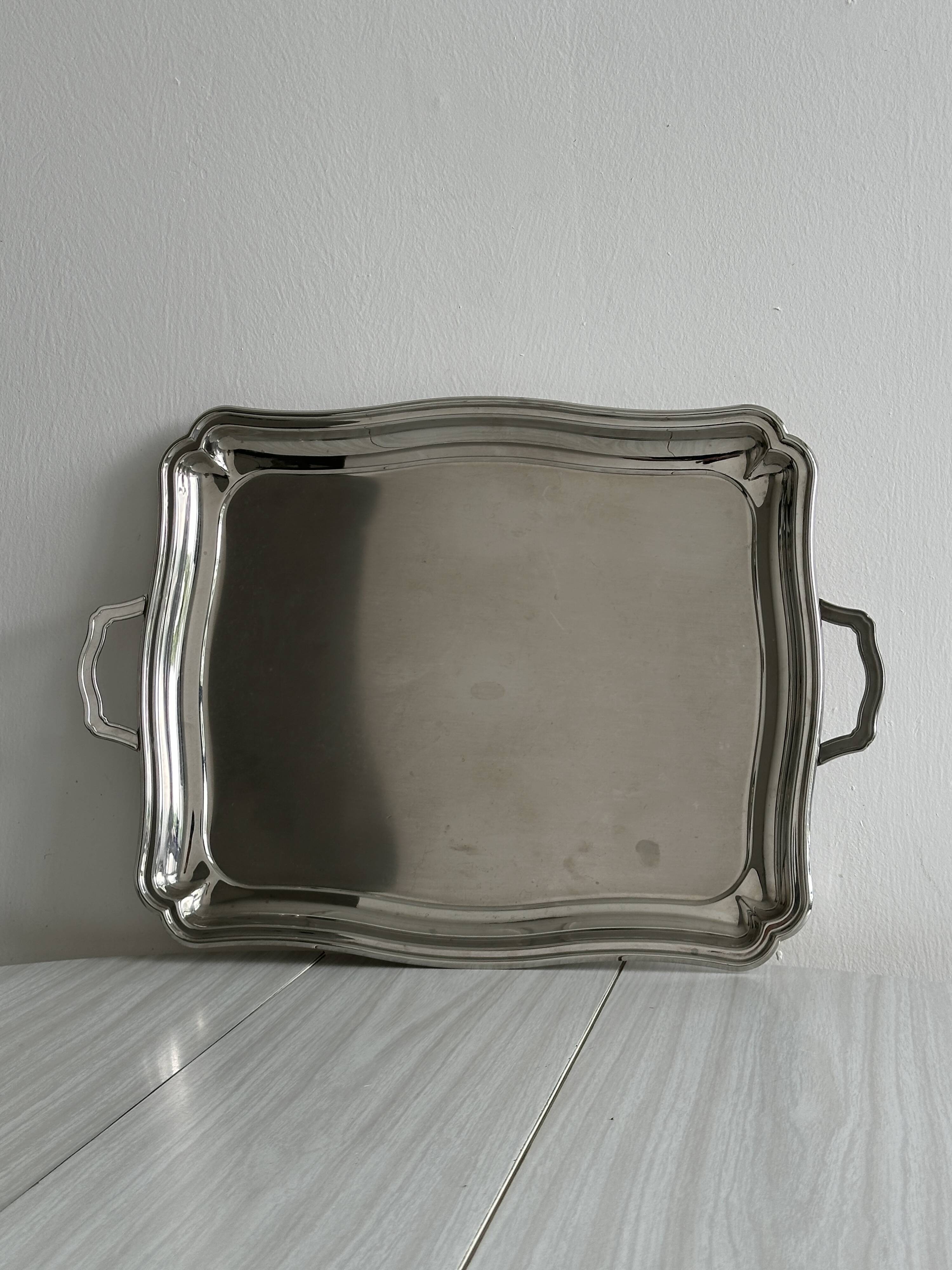 Large shiny metal serving tray