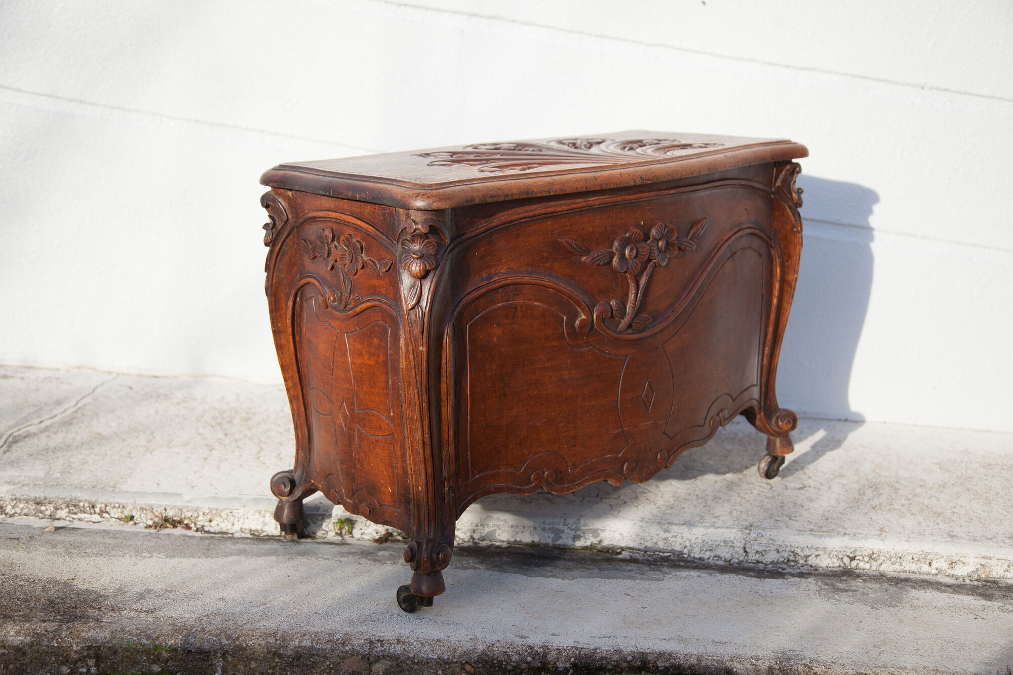 Old chest, carved wooden chest, curved chest on wheels, interior decoration