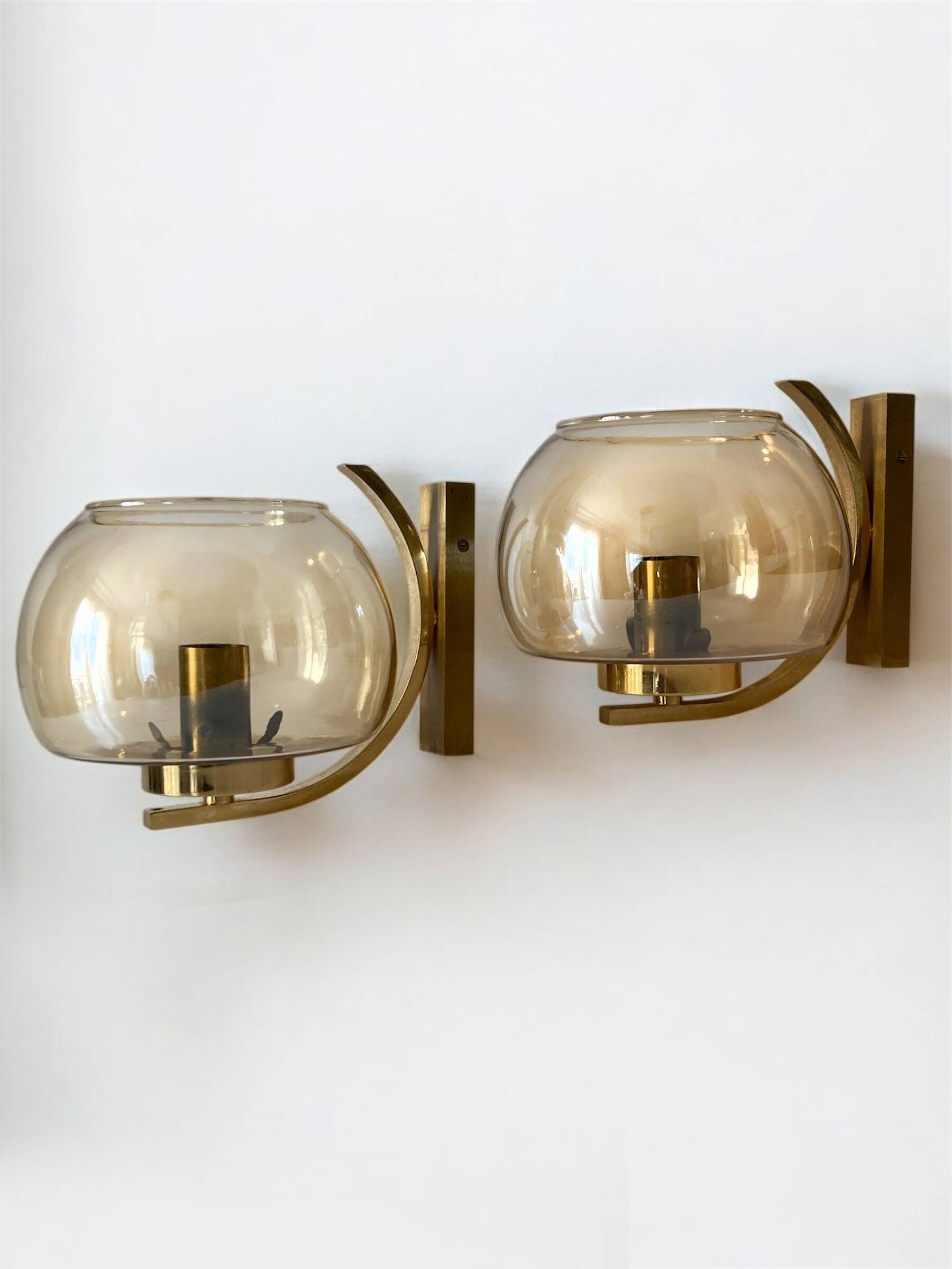 Brass and smoked glass arc wall lights. 1970