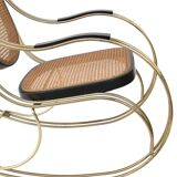 Modernist rocking chair in gilded brass and cane.
