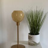 Table lamp with an old vintage glass lampshade, between gold and camel