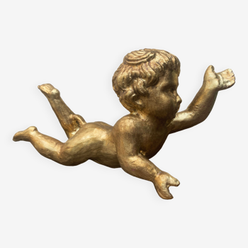 Carved and gilded wooden putto