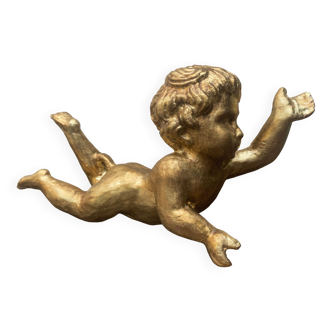 Carved and gilded wooden putto