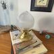 Antique globe table lamp in glass, Holophane type, and brass.