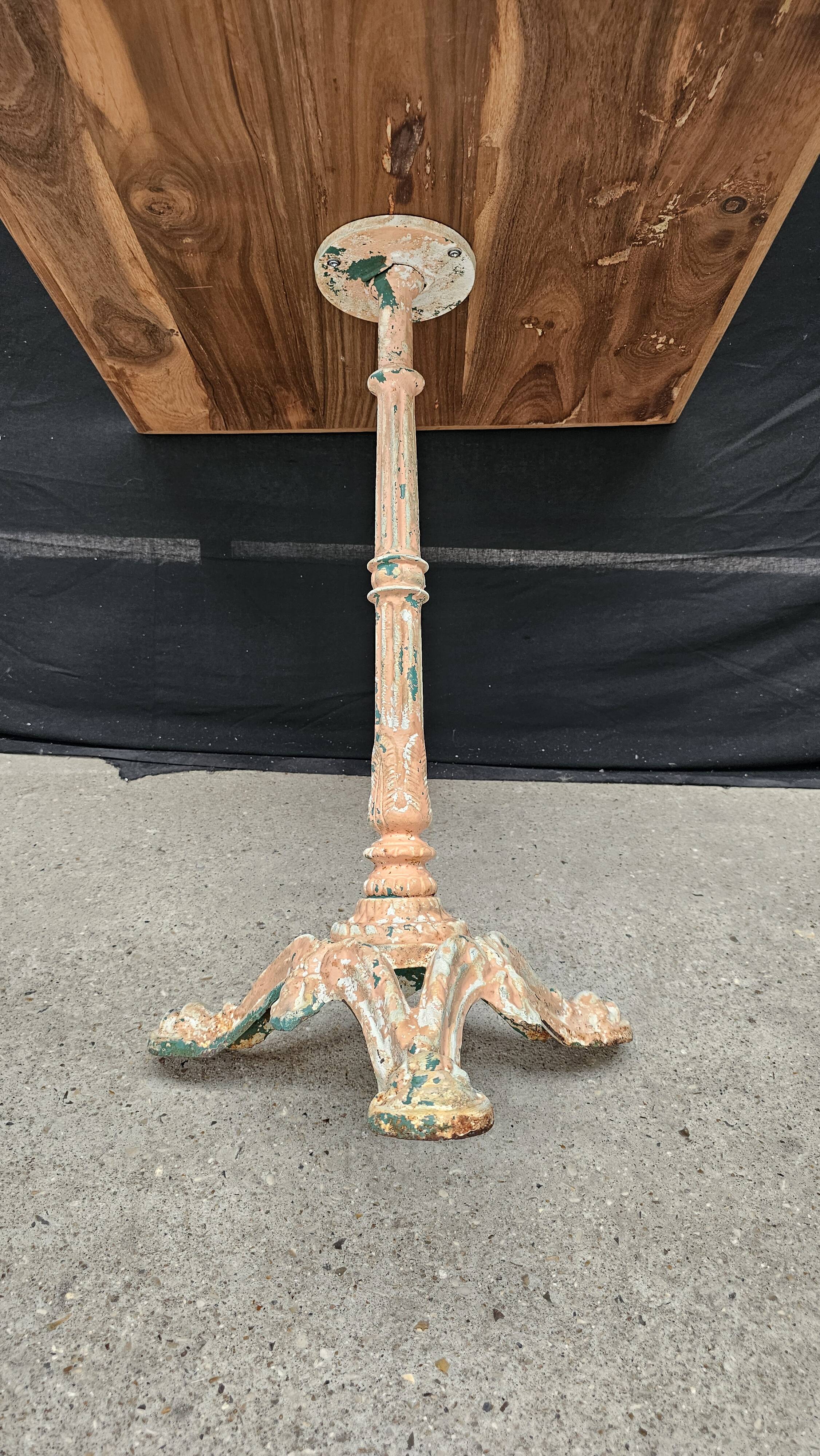 Bistro table with cast iron base and solid teak top