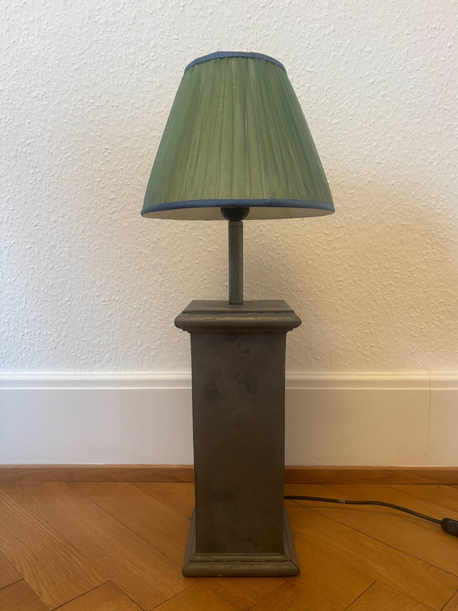 Vintage stone lamp with green pleated shade.