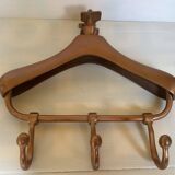 Wall mounted coat rack in the shape of a hanger