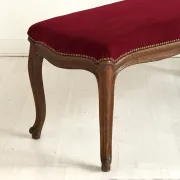 Louis XV style bench in oak and red velvet, 19th century.