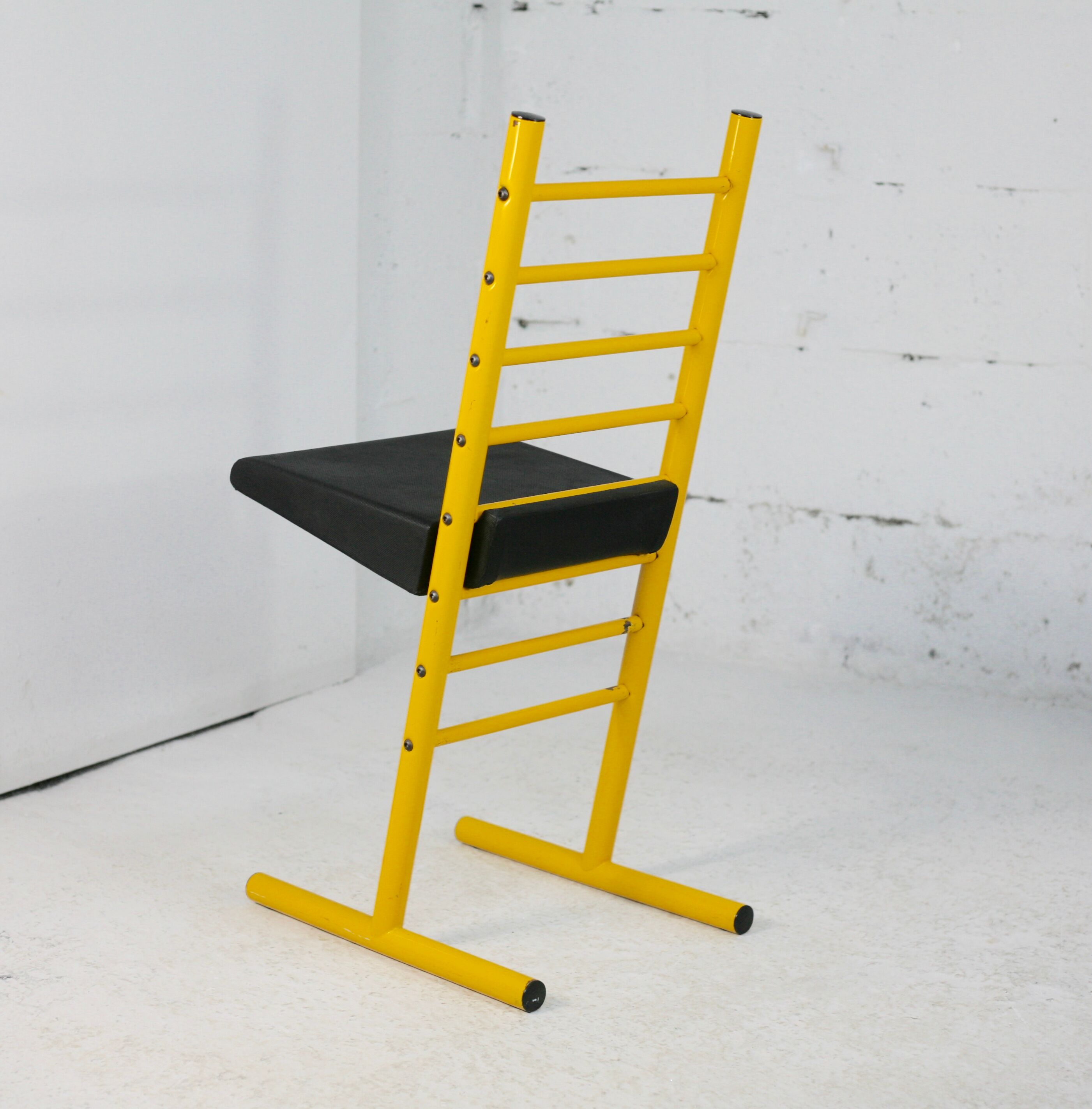 Adjustable seat chair. Circa 1980. Italy. Yellow lacquered steel.