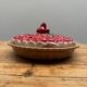 A trompe l’oeil strawberry pie dish