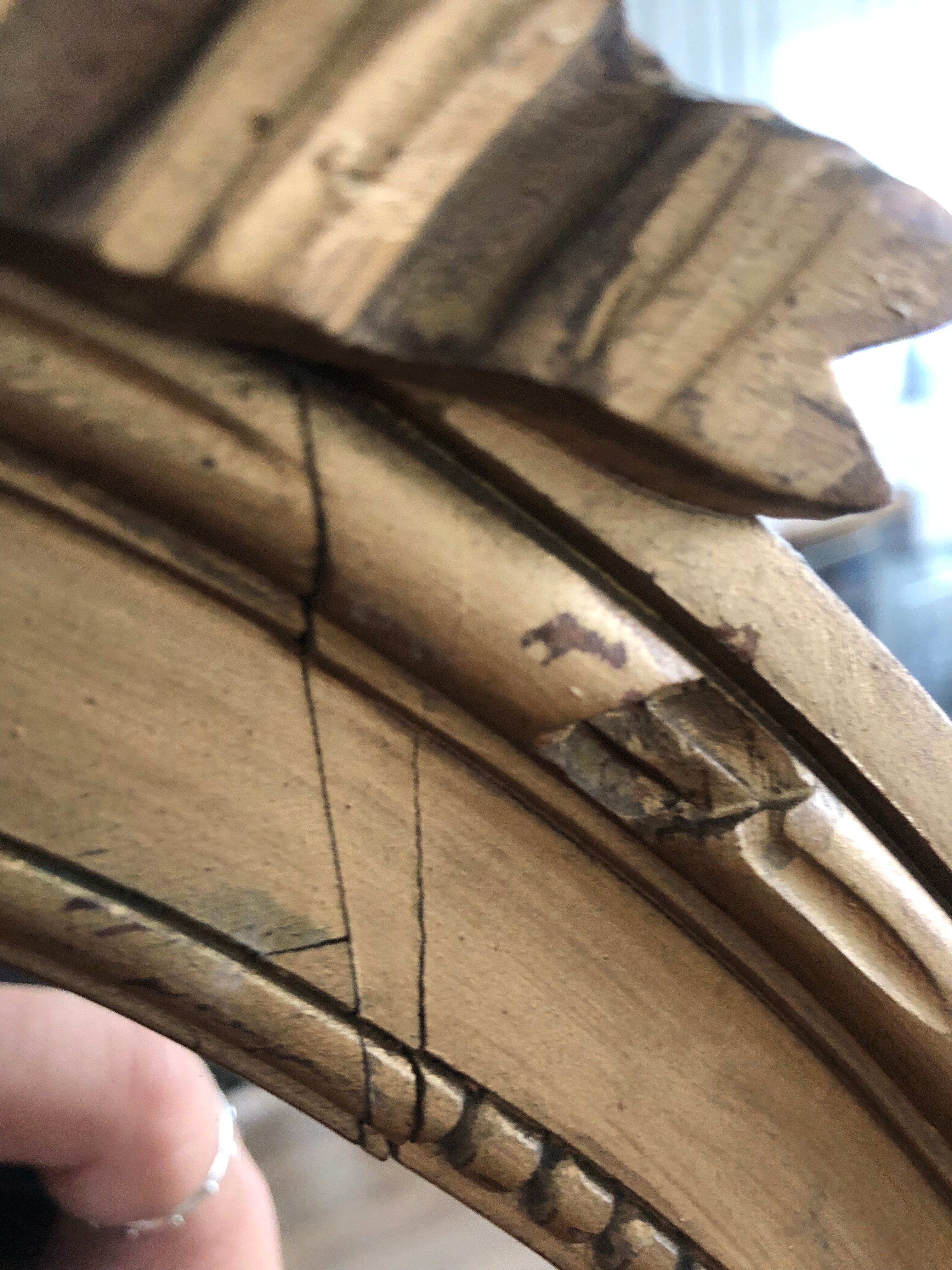 Old oval mirror with a pediment