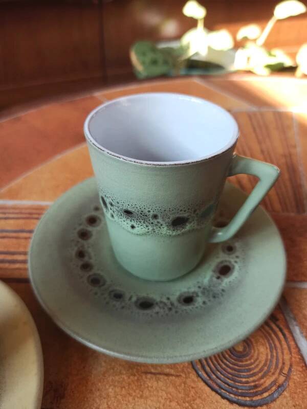 A pair of vintage glazed stoneware cups and saucers.