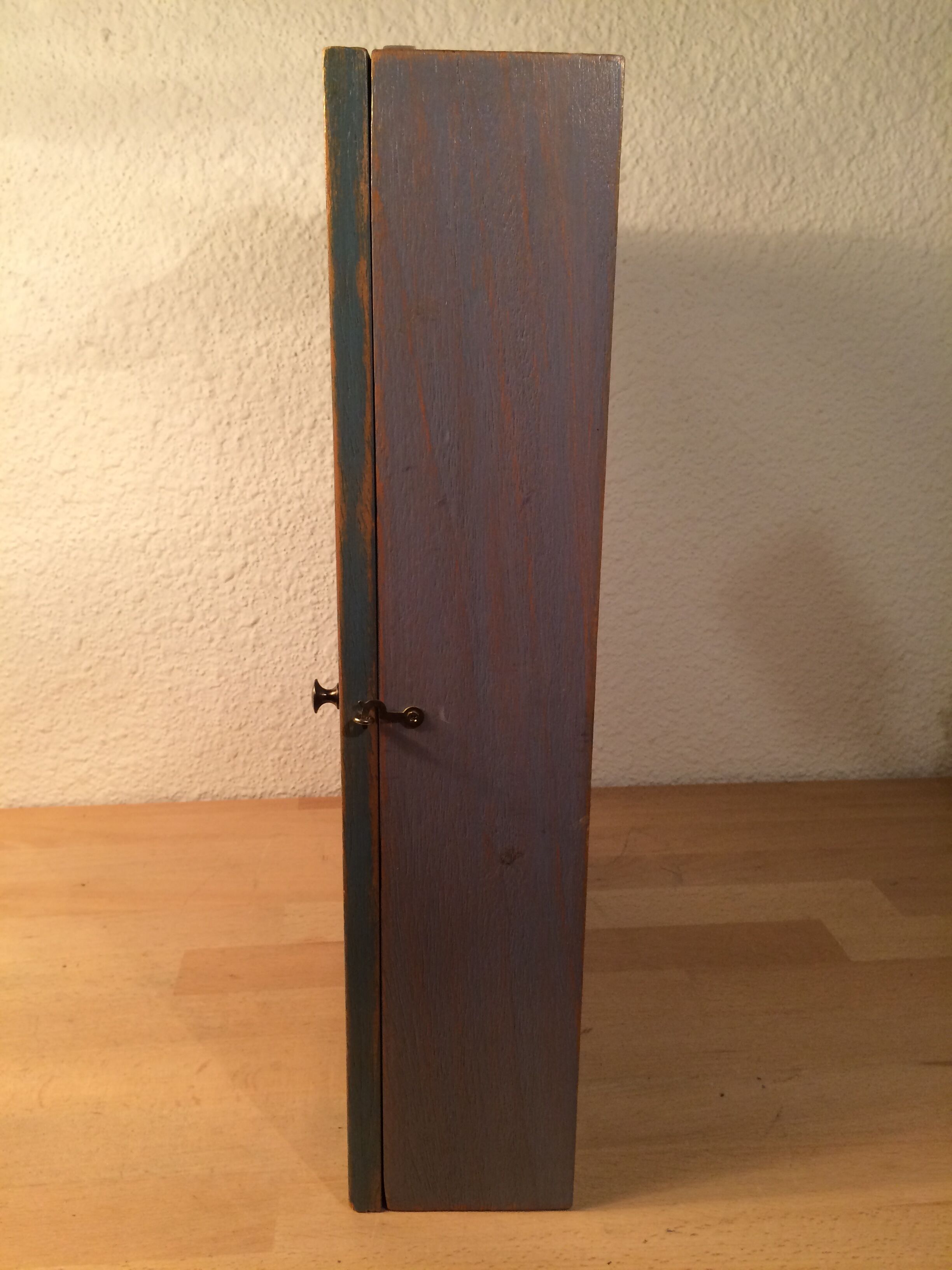 Display shelf with miniature blue wood and mirrors