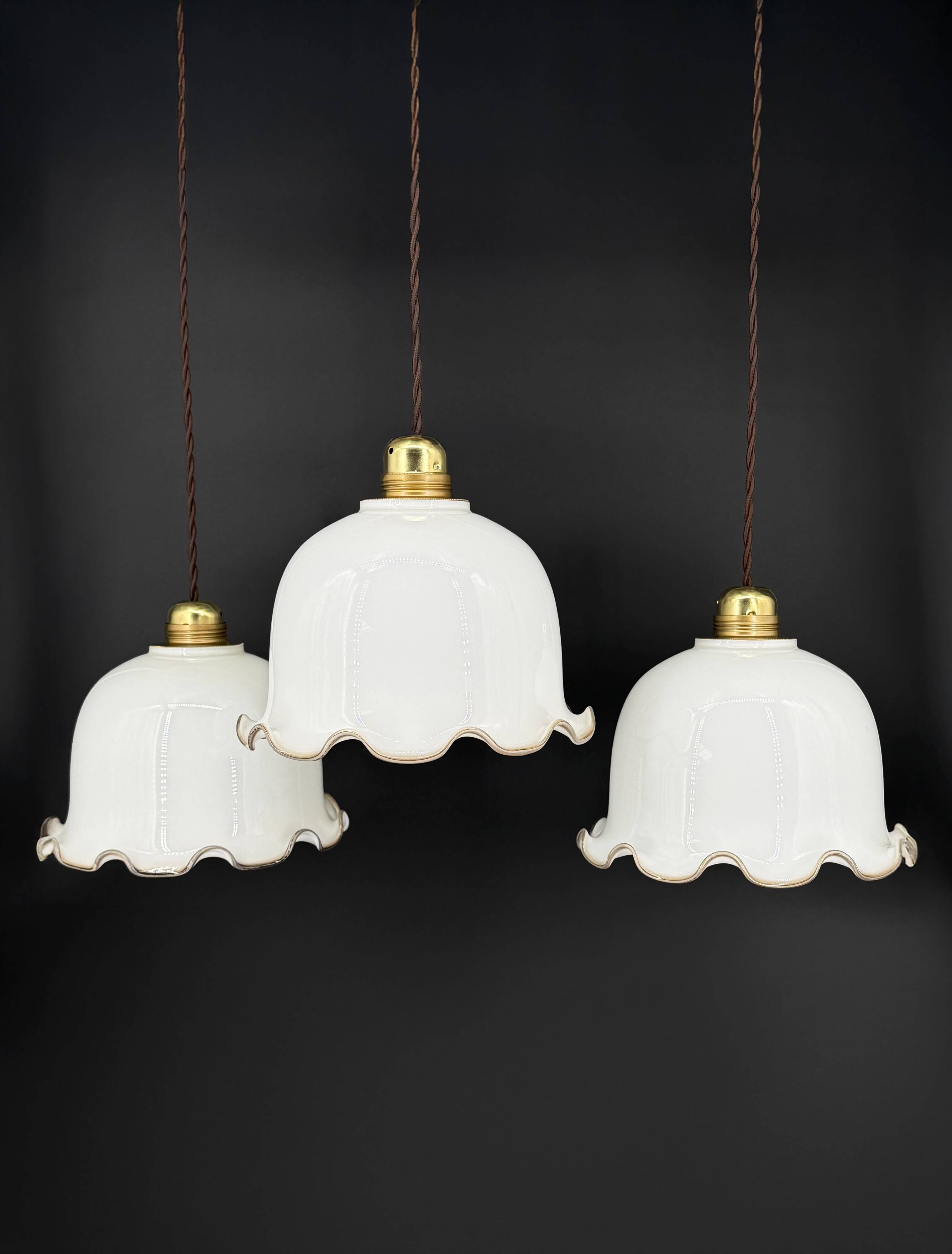 Set of 3 vintage bell-shaped pendants in white opaline with brown trim.