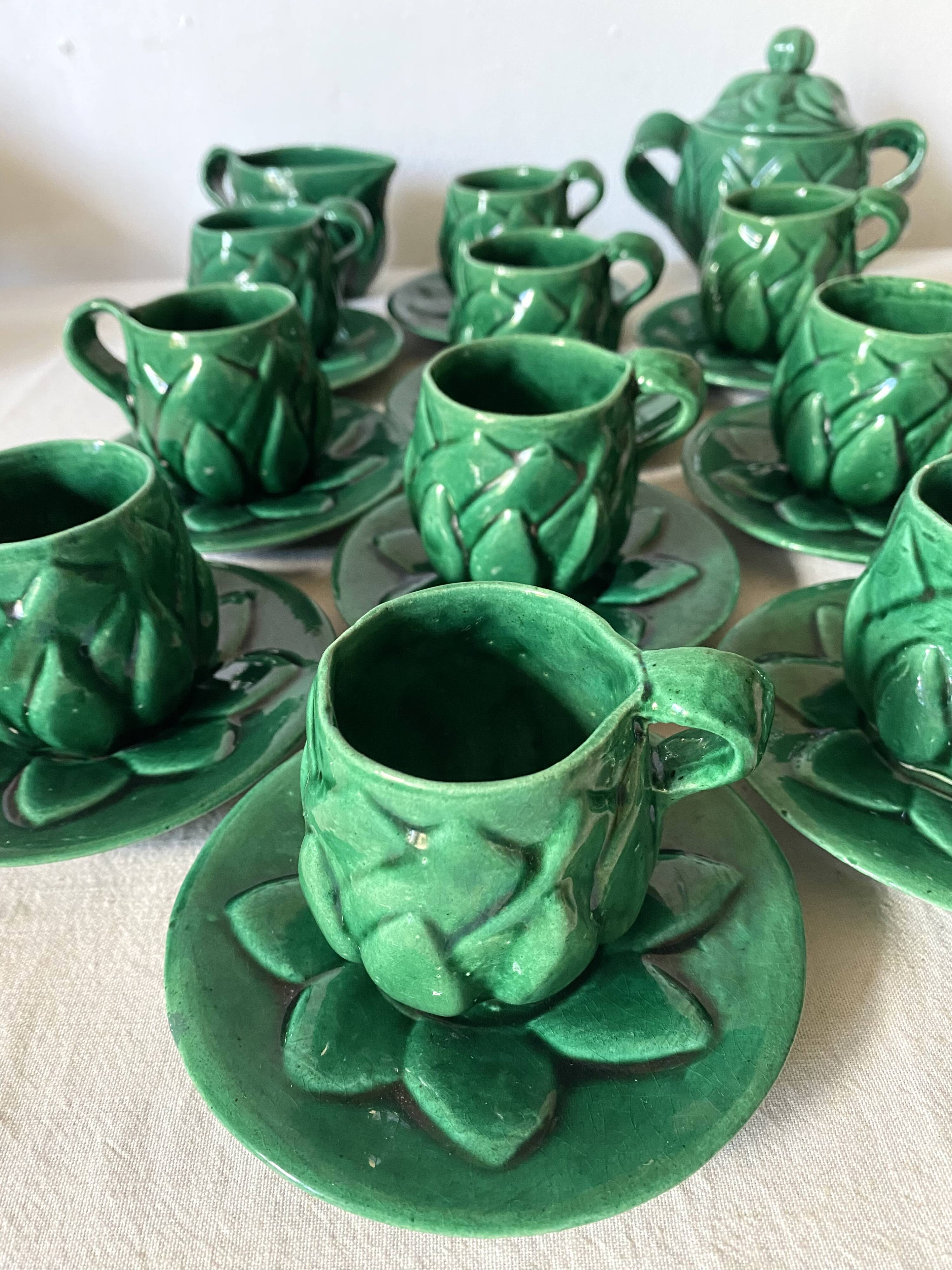 Antique slip cups with saucers, sugar bowl and milk pitcher