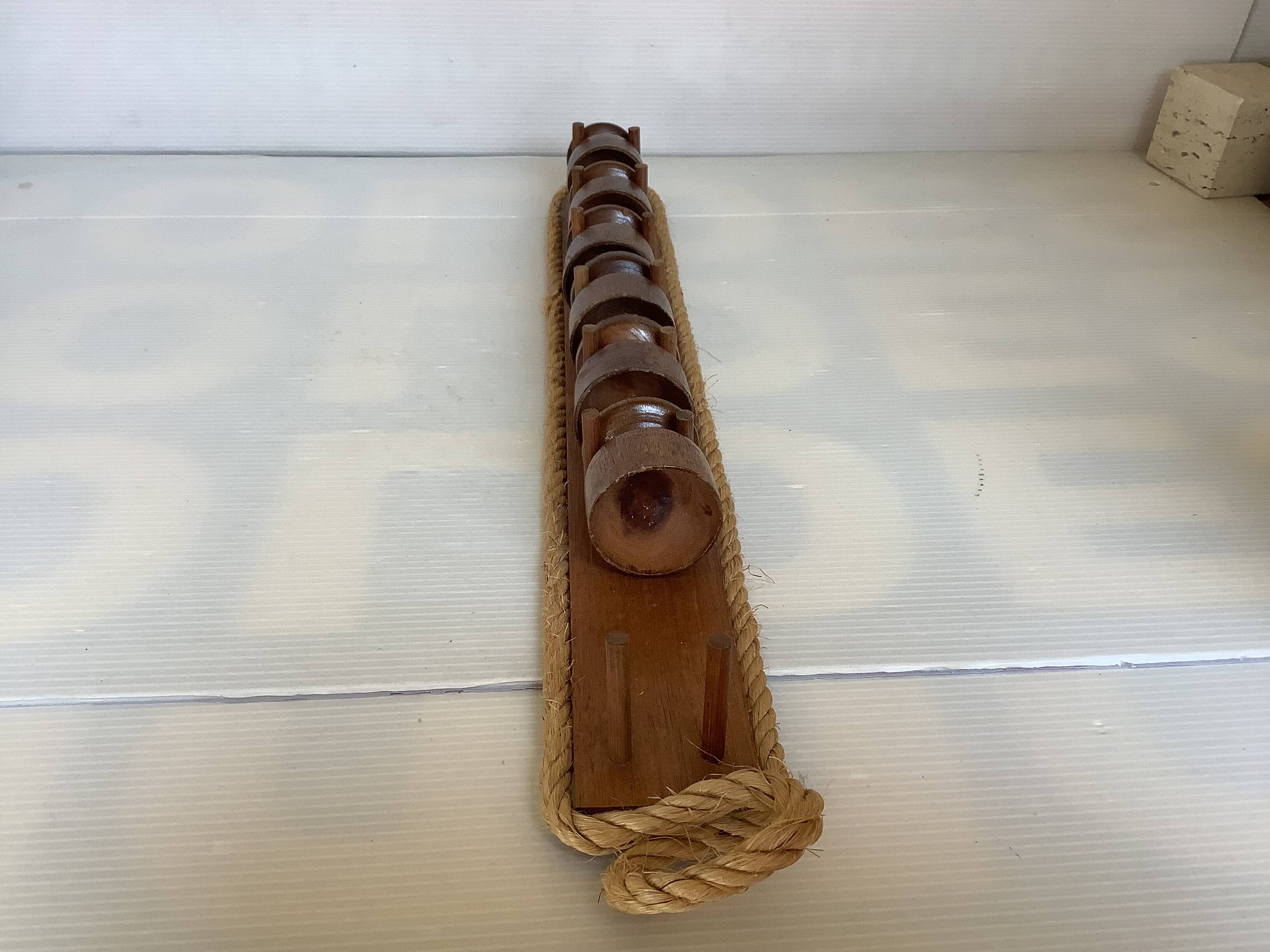 Six wooden egg cups and their rope holder