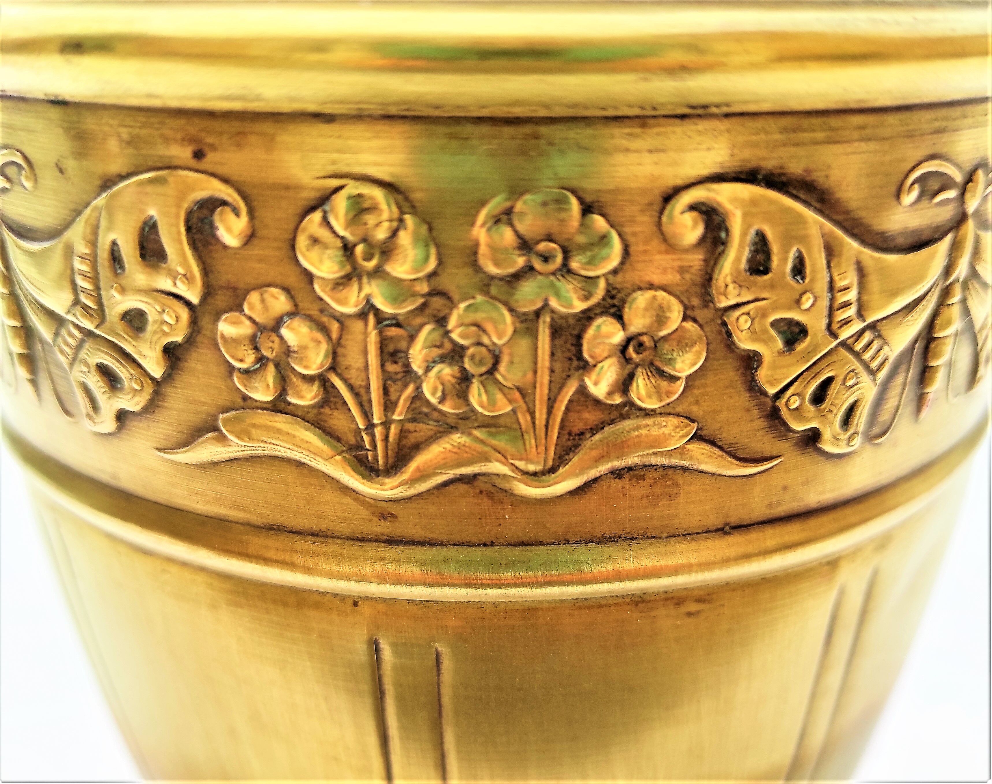 Vase in brass worked with flowers and butterflies around 1930