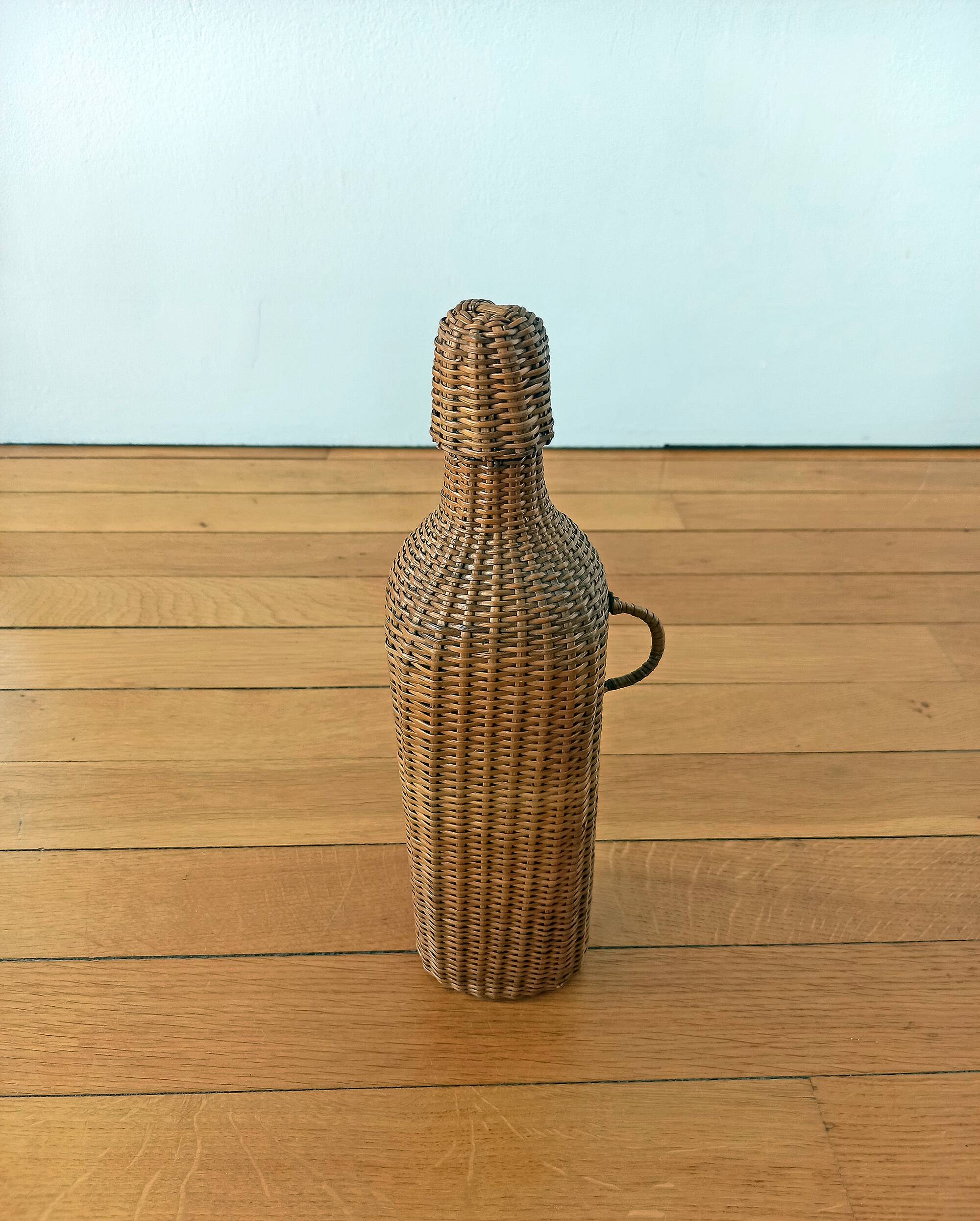 Bottle, old carafe in glass and wicker, 1950s
