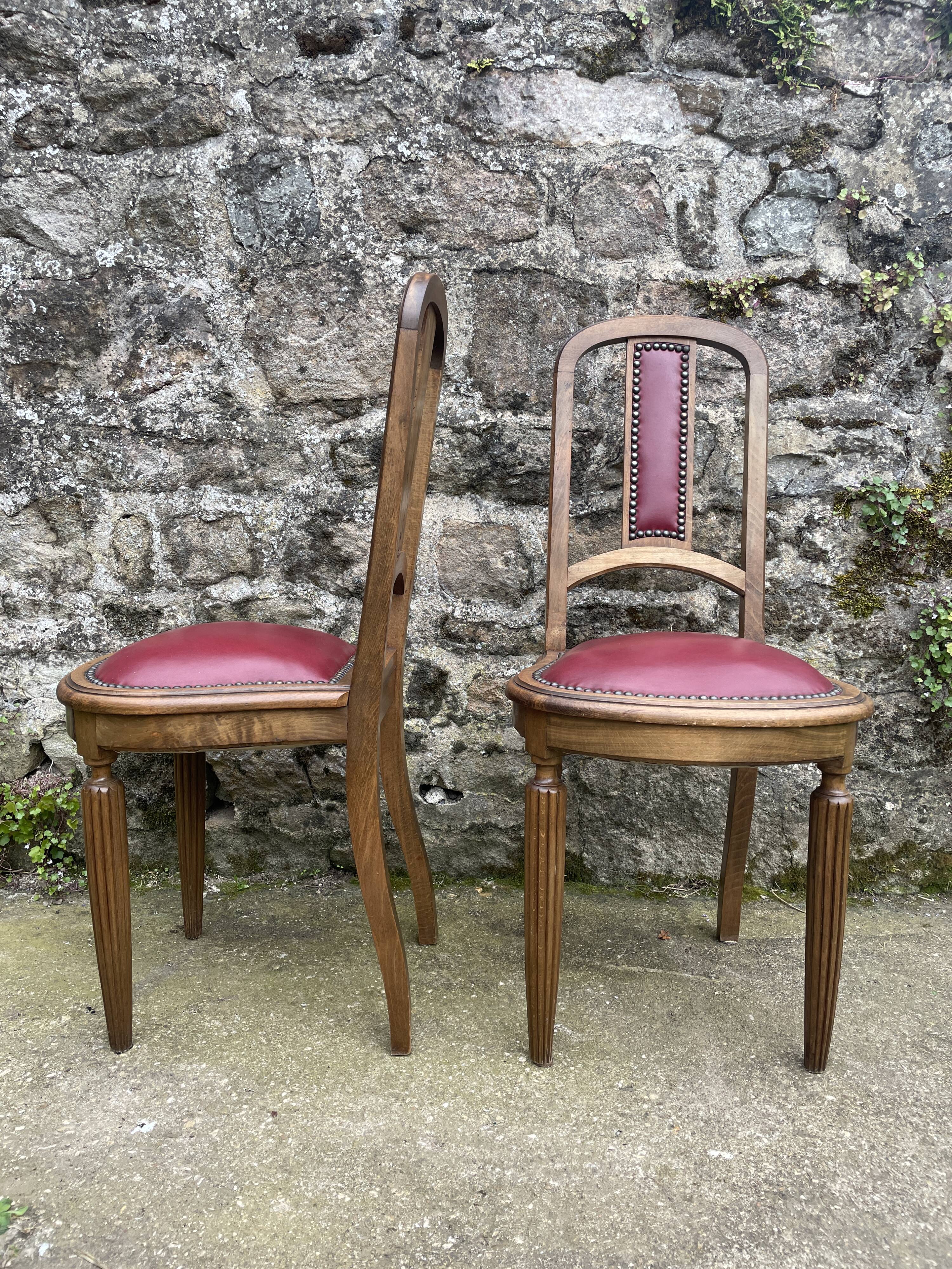 Pair of studded burgundy leather Art Deco chairs