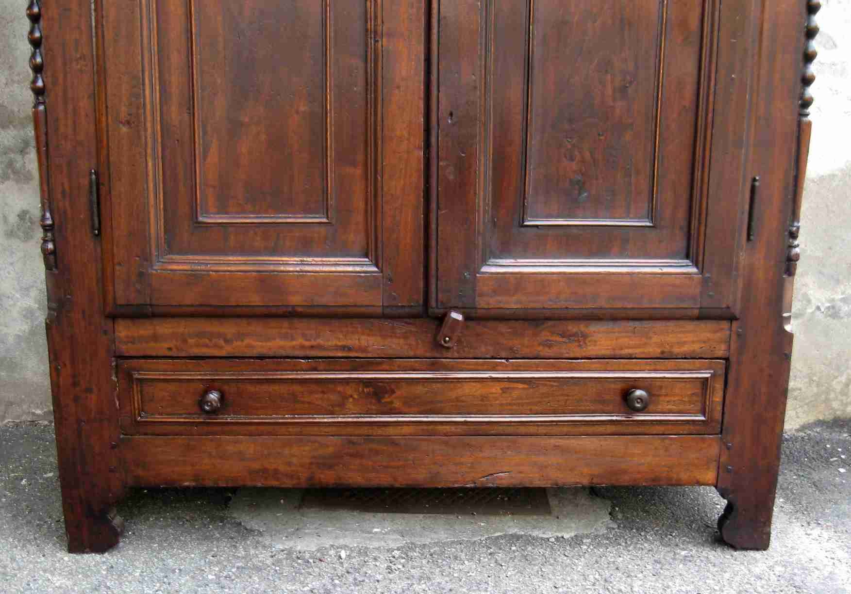 Antique solid wood wardrobe in historical rustic style from the 19th century.