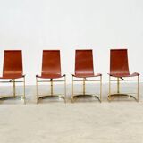 Set of four leather and brass Italian dining chairs