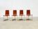 Set of four leather and brass Italian dining chairs