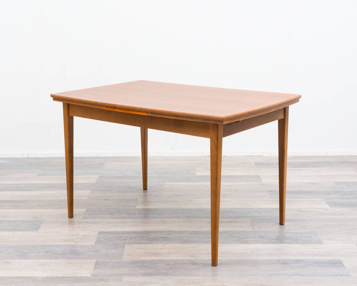 Dining table, 1960s, in walnut, slightly elliptical shape.