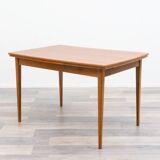 Dining table, 1960s, in walnut, slightly elliptical shape.