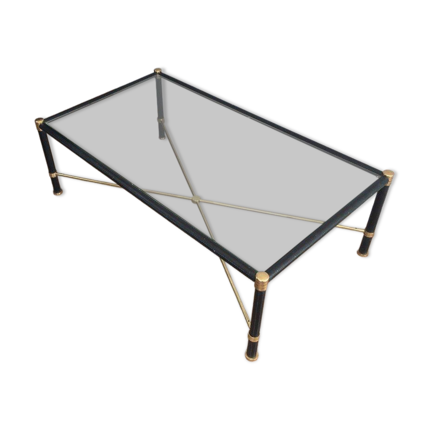 Brass coffee table upholstered in black leather. In the style of Jacques Adnet.