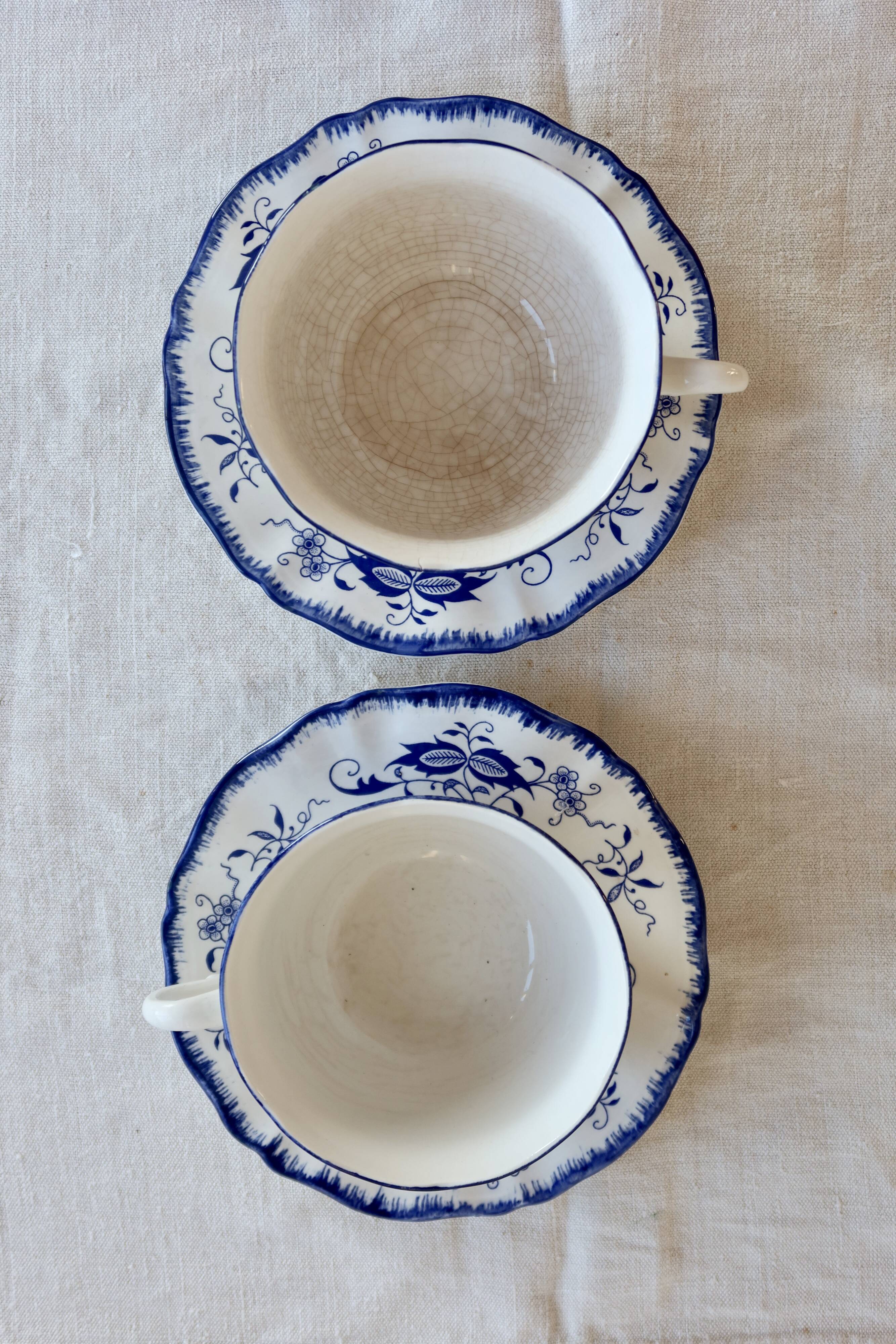 Old Lancaster cups and saucers in white earthenware with blue decoration.