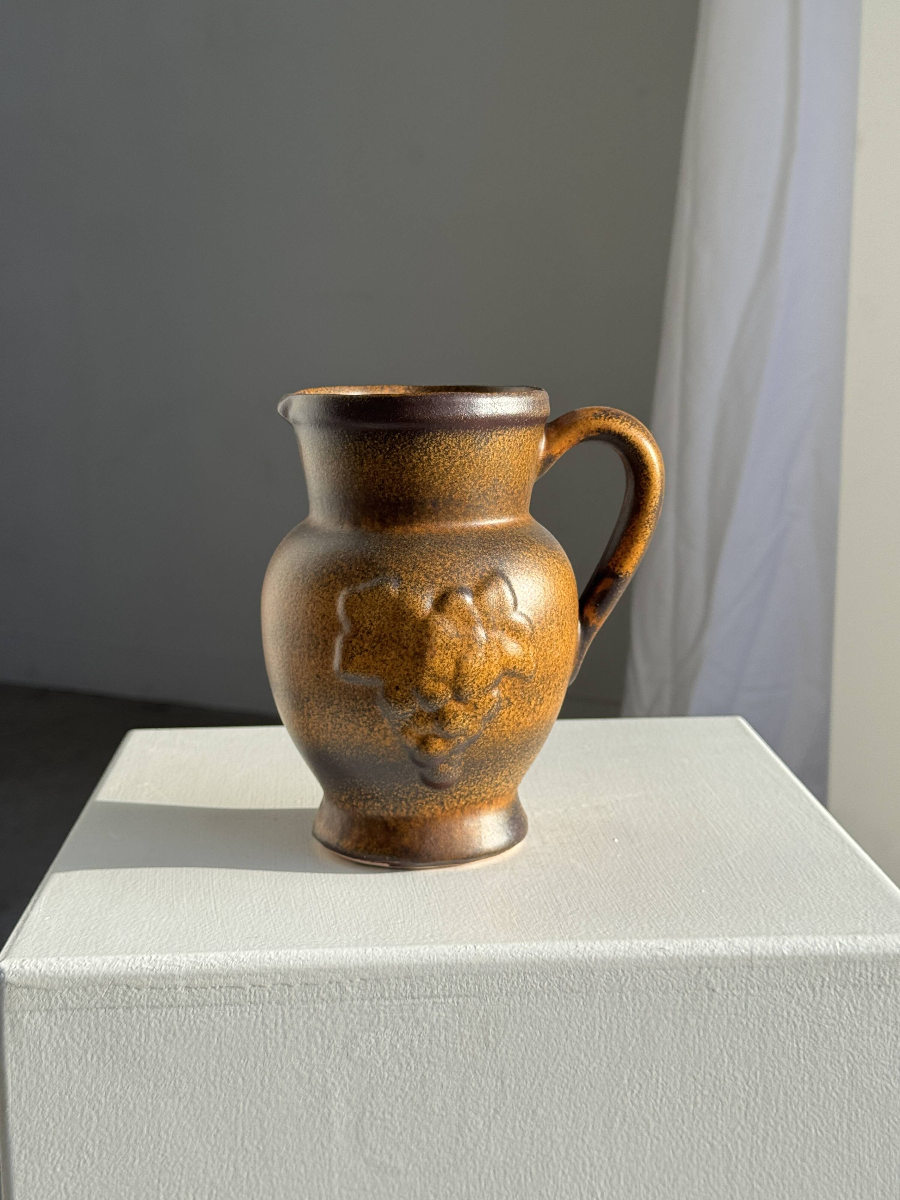 Speckled stoneware jug with grape pattern H17