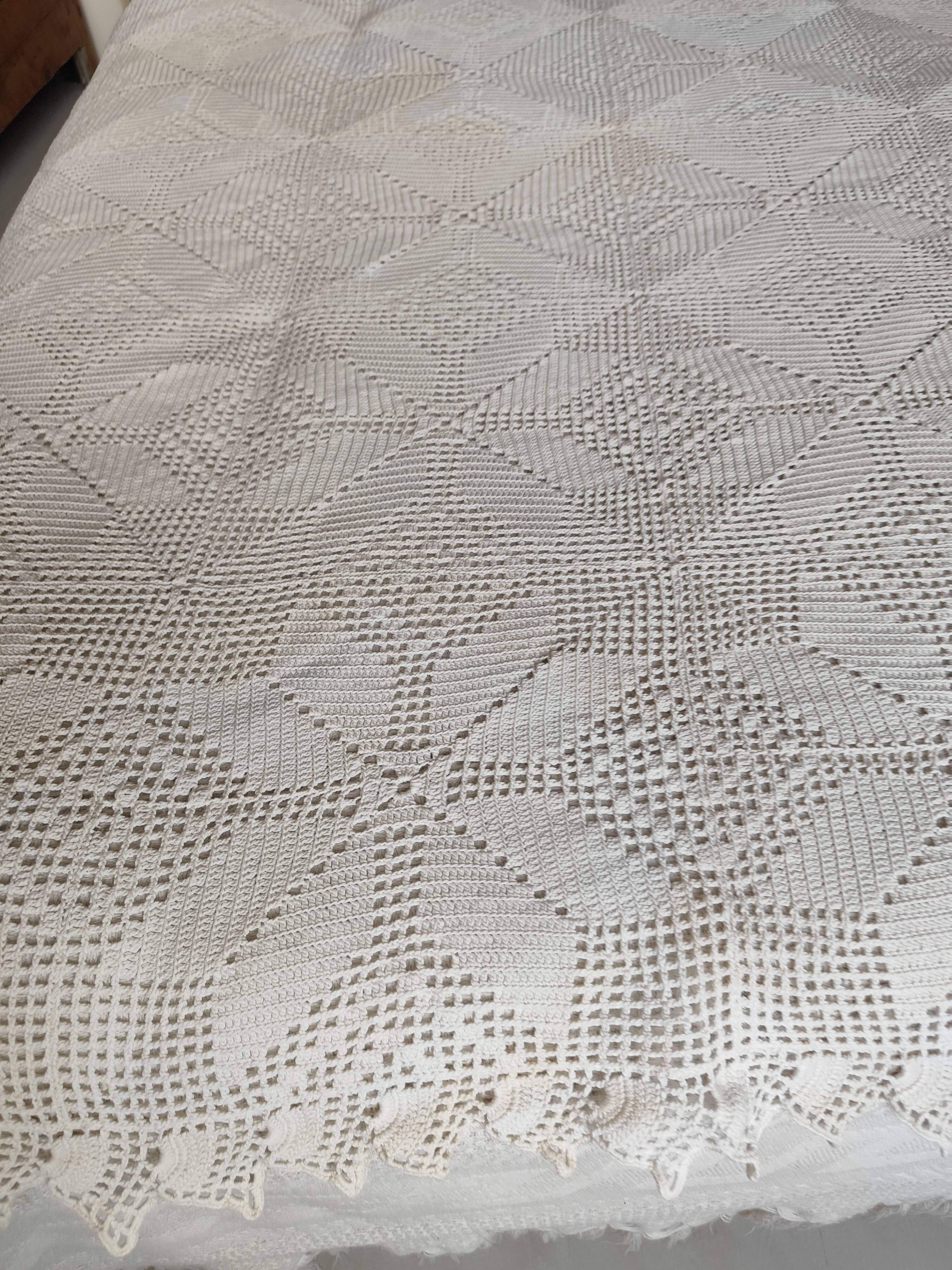 White cotton bedspread, crocheted sofa throw with star patterns